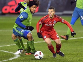 Toronto FC forward Sebastian Giovinco (10) battles looks to pass as Seattle Sounders defender Roman Torres (29) defends during first half MLS Cup final action in Toronto on Saturday, Dec. 10, 2016. Toronto FC is downplaying word from Sebastian Giovinco&#039;s agent that the deep-pocketed Chinese Super League is interested in the star striker. THE CANADIAN PRESS/Frank Gunn