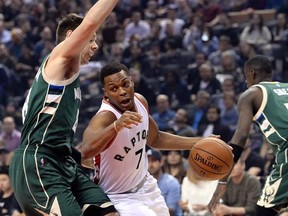 Milwaukee Bucks guard Matthew Dellavedova (8) guards Toronto Raptors guard Kyle Lowry (7) as he drives to the net during first half NBA basketball action in Toronto on Friday, January 27, 2017. THE CANADIAN PRESS/Nathan Denette
