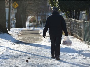 A man navigates an ice-covered sidewalk in Vancouver at the start of January.
