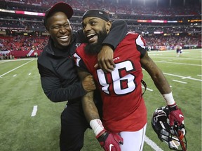 Atlanta Falcons wide receivers coach Raheem Morris and wide receiver Justin Hardy celebrate the 36-20 victory over the Seattle Seahawks on Saturday.