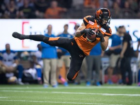 B.C. Lions' Bryan Burnham makes a reception against the Winnipeg Blue Bombers during the second half of a CFL football game in Vancouver, B.C., on Friday October 14, 2016.