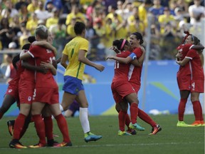 Canada players celebrate after beating Brazil 2-1 on the bronze medal match of the women's Olympic football tournament between Brazil and Canada at the Arena Corinthians stadium in Sao Paulo.