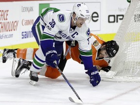 Vancouver Canucks' Henrik Sedin (33) and Philadelphia Flyers' Andrew MacDonald (47) collide during the first period of an NHL hockey game, Thursday, Jan. 12, 2017, in Philadelphia. (AP Photo/Matt Slocum) ORG XMIT: PXC102 ORG XMIT: POS1701121855160823