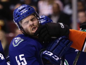 Vancouver Canucks' Michael Chaput is grabbed by his lip by Anaheim Ducks' Nick Ritchie during first period NHL hockey action on Dec. 30 in Vancouver.