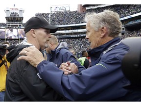 Seattle Seahawks head coach Pete Carroll (right) and Atlanta Falcons head coach Dan Quinn — former colleagues — greet each other after the Hawks eked out a 26-24 win over the Falcons in a game last October at Seattle’s CenturyLink Field.