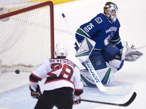 Devils defenceman Damon Severson watches as Taylor Hall's shot goes past Jacob Markstrom in overtime.