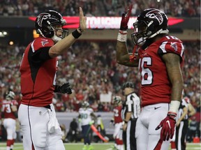 Matt Ryan (left) of the Atlanta Falcons and  Justin Hardy react against the Seattle Seahawks at the Georgia Dome. The Falcons advance to the NFC Championship game with a 36-20 win.