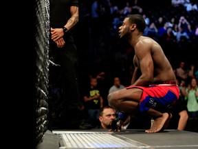 NEWARK, NJ - APRIL 18:  Aljamain Sterling (blue shorts) takes a moment against Takeya Mizugaki of Japan (white and black shorts)  before their bantamweight bout during the UFC Fight Night event at Prudential Center on April 18, 2015 in Newark, New Jersey.  (Photo by Alex Trautwig/Getty Images)