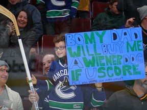 A young fan smiles after receiving a stick from Bo 'Hotdog' Horvat.