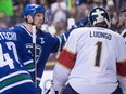 Vancouver Canucks' Henrik Sedin, left, of Sweden, taps former teammate, Florida Panthers' goalie Roberto Luongo on the head after scoring a goal against him to record his 1,000th career point, during the second period of an NHL hockey game in Vancouver, B.C., on Friday January 20, 2017.