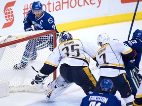 Henrik Sedin's 999th NHL point trickles into the net behind Pekka Rinne on Tuesday night at Rogers Arena.