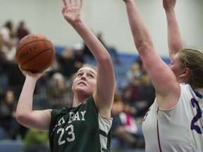 Oak Bay's Imogen White shoots a lay-up against Brookswood's Brooklyn Golt on Saturday in the Top 10 finals in Coquitlam. (Gerry Kahrmann, PNG)