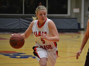 Simon Fraser University's Ellen Kett drives past Jordan McPhee of Seattle Pacific during GNAC women's basketball action.