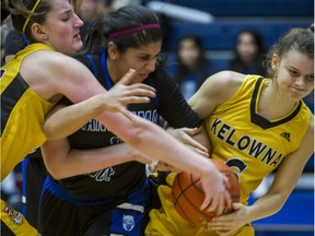 Panorama Ridge's Savannah Dhaliwal (centre) draws a crowd wherever she is on the basketball court.
