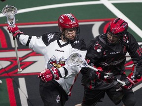 Vancouver Stealth Rhys Duch (#10) pressures Curtis Dickson of the Calgary Roughnecks in a regular season NLL lacrosse game at the Langley Events Centre.