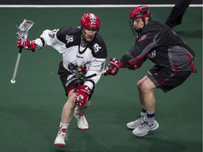 Vancouver Stealth defender Justin Salt (right) pressures Calgary Roughnecks sniper Curtis Dickson during a Jan. 14 regular season NLL game at the Langley Events Centre.