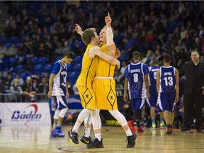 Kelowna's Parker Simson raises his arms in celebration of a B.C. championship title last March at the Langley Events Centre. Richard Lam/PNG files