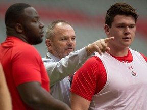 Canada head coach Mark Anscombe, centre, directs his players as they warm up before a rugby test match against Japan in Vancouver, B.C., on Saturday June 11, 2016.