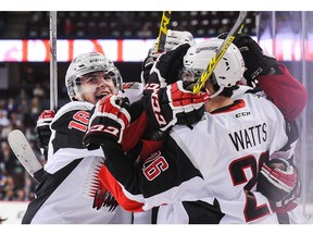 Brayden Watts, right, then of the Moose Jaw Warriors, celebrates with teammates after scoring against the Hitmen at Scotiabank Saddledome in Calgary. Watts was dealt to the Vancouver Giants this week.