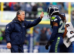 Seattle coach Pete Carroll speaks with defensive star Richard Sherman, who he will be counting on Saturday night when the Seahawks open the NFL playoffs against the Detroit Lions at CenturyLink Field in the NFC Wild-Card game in Seattle.