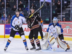 CALGARY, AB - DECEMBER 18: Dallas Hines and Payton Lee of the Kootenay Ice defend net against Beck Malenstyn of the Calgary Hitmen during a WHL game at Scotiabank Saddledome on December 18, 2016 in Calgary, Alberta, Canada. (Photo by Derek Leung/Getty Images)