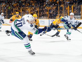 Brandon Sutter of the Canucks shoots the puck against the Predators.