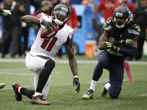 Atlanta Falcons wide receiver Julio Jones reacts after Seahawks cornerback Richard Sherman, right, broke up a pass intended for him Oct. 16 in Seattle. Jones and the Falcons get another shot at Seattle in Saturday's round playoff game.