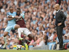 Manchester City's Raheem Sterling (far left) and West Ham defender Arthur Masuaku — with City coach Pep Guardiola looking on — will renew acquaintances in their FA Cup third-round match on Friday.