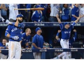 Toronto Blue Jays Jose Bautista tosses his bat after hitting a three-run home run during seventh inning game five American League Division Series baseball action against the Texas Rangers in Toronto on Wednesday, October 14, 2015.