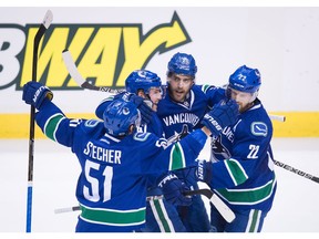 Troy Stecher, Sven Baertschi, Brandon Sutter and Daniel Sedin celebrate one of Baertschi's two goals.