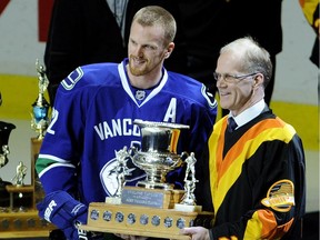 Vancouver's Daniel Sedin receives the Cyclone Taylor Award as the team's most valuable player from former Canucks star Thomas Gradin at the start of the game against Minnesota at Rogers Arena on April 7, 2011. Mark van Manen/PNG files