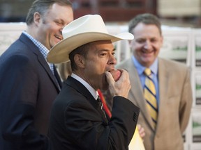 Agriculture Minister Norm Letnick takes a bite of an apple at an agrifood announcement last February. He'll no doubt be eating fancier fare at Premier Christy Clark's secretive, $5,000-a-plate dinner on Jan. 26.