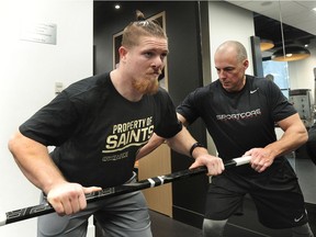 Adam Bighill, left, who recently signed with the NFL's New Orleans Saints, works out with fitness guru Rob Williams at SportsCore Performance in Vancouver Jan. 25.