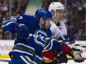 VANCOUVER January 06 2017.  Vancouver Canucks #17 Anton Rodin and Calgary Flames #23 Sean Monahan jostle in the first period of a regular season NHL hockey game at Rogers Arena, Vancouver, January 06 2017.  Gerry Kahrmann  /  PNG staff photo) ( Prov / Sun Sports ) 0007239A  [PNG Merlin Archive]