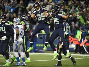 Doug Baldwin, centre, of the Seattle Seahawks celebrates with Jermaine Kearse after scoring a 13-yard touchdown against the Detroit Lions in the NFC Wild Card in Seattle Saturday. The Seahawks won 26-6.