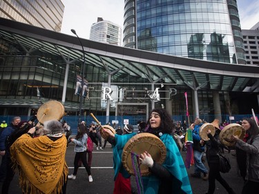 Women beat drums and chant as they march past the still under construction Trump International Hotel and Tower during a women's march and protest against U.S. President Donald Trump, in Vancouver, B.C., on Saturday January 21, 2017. Protests are being held across Canada today in support of the Women's March on Washington. Organizers say 30 events in all have been organized across Canada, including Ottawa, Toronto, Montreal and Vancouver.