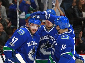 Sven Baertschi celebrates his goal with Bo Horvat and Alex Burrows.