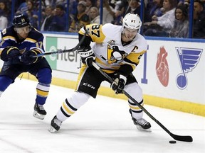 Pittsburgh Penguins&#039; Sidney Crosby, right, controls the puck as St. Louis Blues&#039; Jaden Schwartz defends during the third period of an NHL hockey game Saturday, Feb. 4, 2017, in St. Louis. The Penguins won 4-1. (AP Photo/Jeff Roberson)
