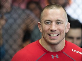 MONTREAL, QUE.: FEBRUARY 28, 2014 -- MMA fighter Georges St-Pierre looks on as he teaches fighting techniques to a group of prize winners during a 'Get in the Cage' event at Tristar Gym in Montreal on Friday, February 28, 2014. (Dario Ayala / THE GAZETTE) ORG XMIT: 49333