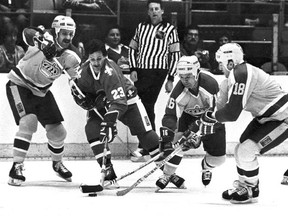 Jacques Richard, (23) of the Quebec Nordiques, is surrounded by the Los Angeles Kings&#039; Charlie Simmer (11), Marcel Dionne (16) and Dave Taylor (18) as they scramble for possession of the puck during first-period action at the Forum in Los Angeles, Calif. Thursday March 18, 1983. Sometimes when three players click on the same line, like Dionne, Simmer and Taylor, the unit becomes bigger than the sum of its parts.THE CANADIAN PRESS/ AP/Alvin Chung
