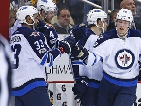 Winnipeg Jets&#039; Patrik Laine (29) celebrates his goal with Dustin Byfuglien (33) as he returns to the bench during the second period of the team&#039;s NHL hockey game against the Pittsburgh Penguins in Pittsburgh on Feb. 16, 2017. THE CANADIAN PRESS/AP, Gene J. Puskar