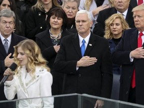 FILE - In this Jan. 20, 2017, file photo, Vice President Mike Pence and President Donald Trump listen to the singing of the national anthem by Jackie Evancho during the 58th Presidential Inauguration at the U.S. Capitol in Washington. Evancho asked Trump in a tweet on Feb. 22, 2017, to meet with her and her transgender sister on transgender rights. (AP Photo/Andrew Harnik, File)