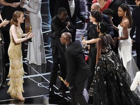 Jordan Horowitz, far left, producer of &ampquot;La La Land,&ampquot; and cast member Emma Stone greet &ampquot;Moonlight&ampquot; cast members and filmmakers onstage after &ampquot;Moonlight&ampquot; was announced as the true winner of best picture at the Oscars on Sunday, Feb. 26, 2017, at the Dolby Theatre in Los Angeles. It was originally announced mistakenly that &ampquot;La La Land&ampquot; was the winner. (Photo by Chris Pizzello/Invision/AP)