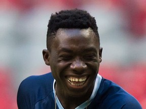 Vancouver Whitecaps Alphonso Davies laughs while warming up with his teammates before a CONCACAF Champions League match against Sporting Kansas City in Vancouver on Aug. 23, 2016.