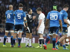 England's Owen Farrell speaks with referee Romain Poite during the Six Nations rugby union match between England and Italy at Twickenham stadium in London, Sunday, Feb. 26, 2017.