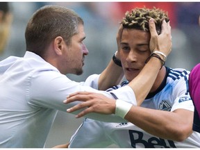 Whitecaps manager Carl Robinson congratulates striker Erik Hurtado on his goal against Sporting Kansas City during CONCACAF Champions League play in Vancouver on Aug. 23, 2016.