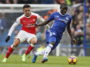 Chelsea's N'Golo Kante, right, holds off the challenge of Arsenal's Alexis Sanchez during the English Premier League match at Stamford Bridge stadium in London on Feb. 4.