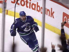 Vancouver Canucks defenceman Christopher Tanev (8) celebrates his game-winning goal against the Calgary Flames during overtime NHL hockey action in Vancouver on Saturday, February 18, 2017.
