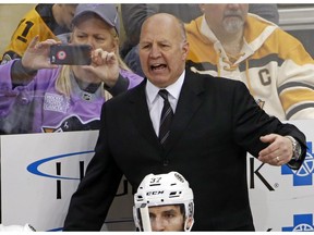 FILE - In this Jan. 22, 2017 file photo, Boston Bruins head coach Claude Julien motions to an official during the first period of an NHL hockey game against the Pittsburgh Penguins in Pittsburgh. On Tuesday, Feb. 7, 2017, the Bruins fired Julien, who was in his 10th season as head coach, and named assistant Bruce Cassidy interim coach.