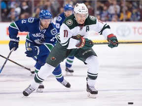 Minnesota Wild's Zach Parise, front, is chased by Vancouver Canucks' Daniel Sedin during a game in November.